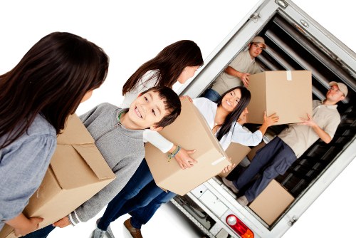 Professional movers handling local removals in Enfield on a residential street